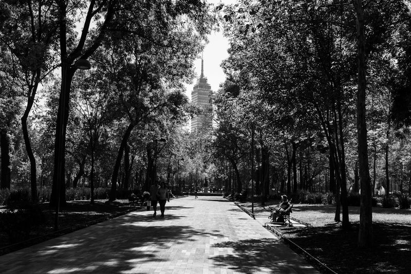 Black and white view of Alameda Central park with Torre Latinoamericana tower in the background