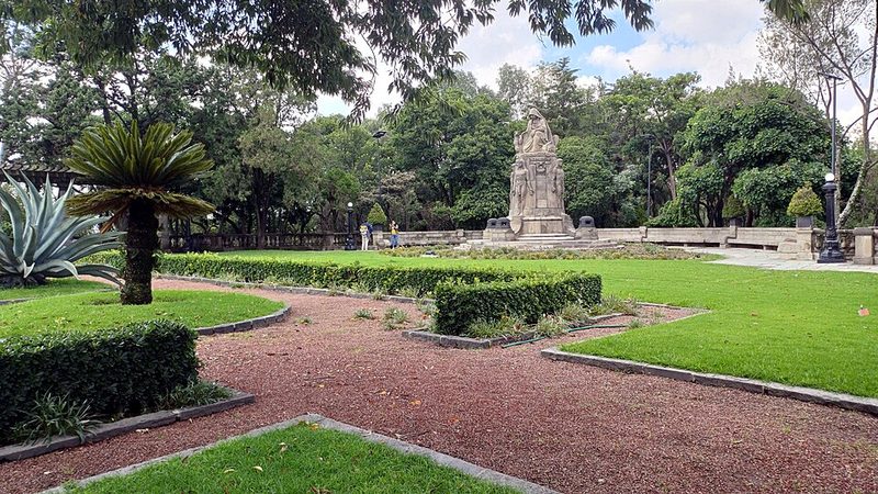 Beautifully landscaped lateral garden at Chapultepec Castle with trees and historic architecture