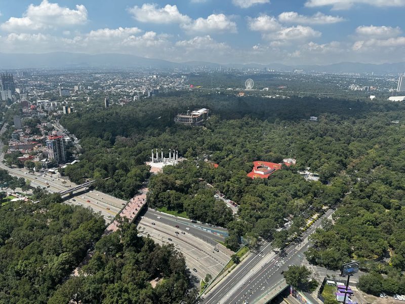 Stunning aerial view of Chapultepec Park with cityscape and mountains in the background