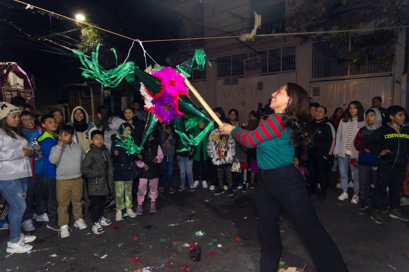 Lively night street celebration with a colorful pinata in Coyoacan Mexico City