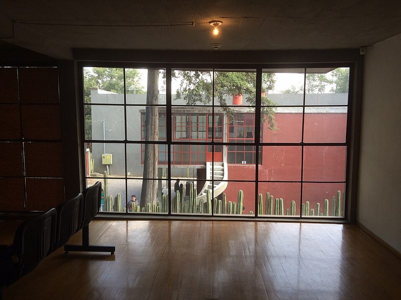 Large window in Diego Rivera house with view toward Juan O Gorman house in San Angel