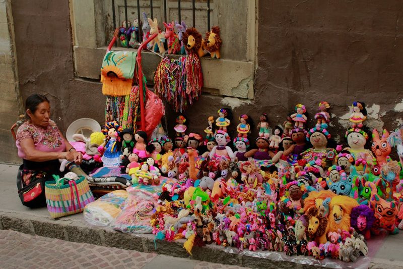 Vibrant display of handmade toys and crafts on a street in Guanajuato Mexico