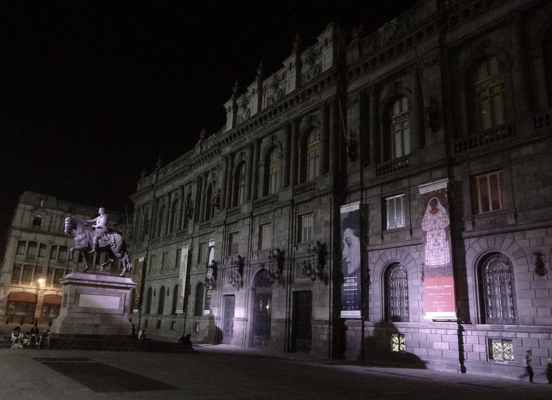 The illuminated facade of MUNAL National Art Museum at night in Mexico City