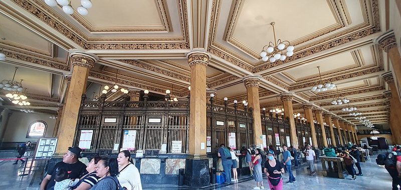 Ornate brass service windows at the Palacio Postal where visitors can still mail letters