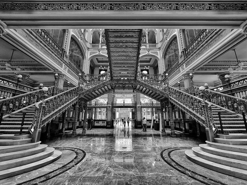 Grand staircase inside the Palacio de Correos de Mexico with ornate ironwork railings