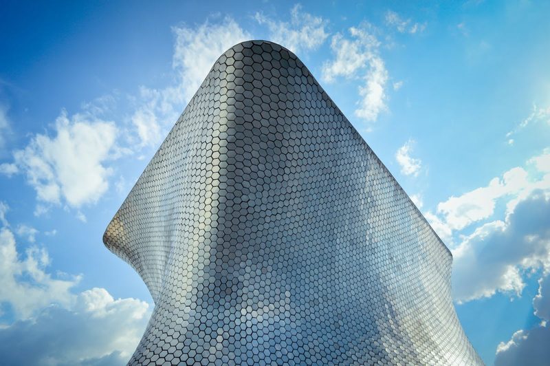 Modern and futuristic Soumaya Museum building against a bright sky in Mexico City