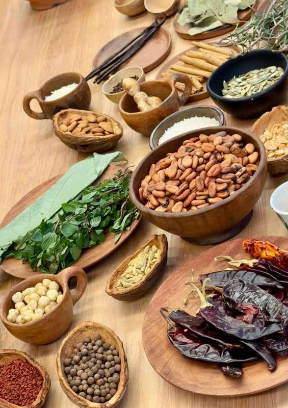 Bean to Beverage: Roast and grind cacao into chocolate - Grinding cacao by hand on a metate