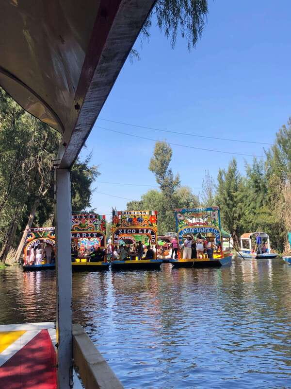 "Floating Party in Xochimilco: Canals, Tequila, and Tradition" - The trajinera ride and the canal views